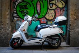 I found this bike parked in a dark alley, I liked the white against the colourful graffiti.